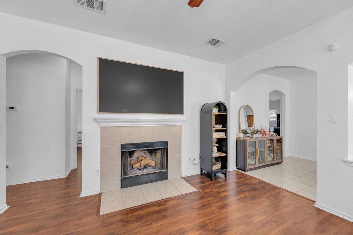 8901 Meridian Oak Lane Austin, TX 78744 - Photo 6 of 26 a living room with fireplace and a flat screen tv