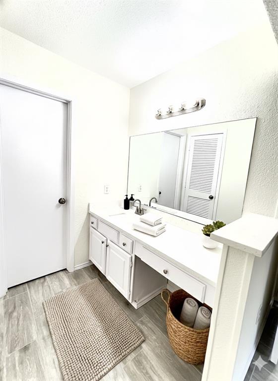 1508 Grantbrook Lane Dallas, TX 75228 - Photo 3 of 11 a spacious bathroom with a double vanity sink and mirror