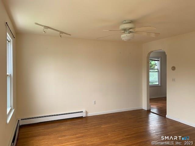 23 Fairview Avenue, Unit 2 Norwalk, CT 06850 - Photo 1 of 15 a view of an empty room with wooden floor and a window