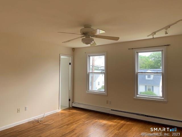 23 Fairview Avenue, Unit 2 Norwalk, CT 06850 - Photo 5 of 15 a view of an empty room with a window and wooden floor