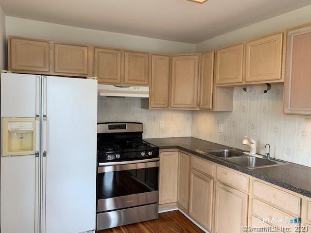23 Fairview Avenue, Unit 2 Norwalk, CT 06850 - Photo 9 of 15 a kitchen with granite countertop white cabinets and stainless steel appliances