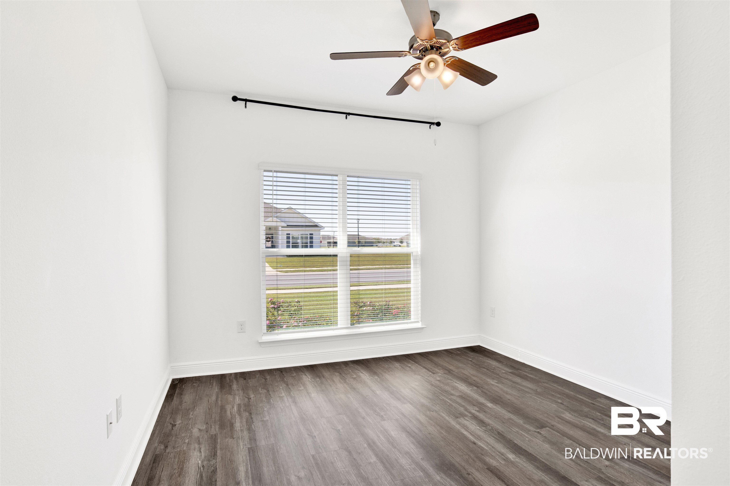 11602 Genuine Risk Circle Daphne, AL 36526 - Photo 20 of 30 Empty room with dark wood finished floors and ceiling fan