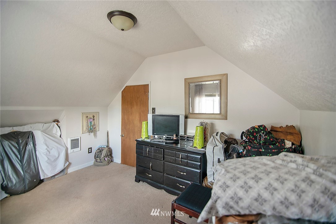 1009 Hilltop Road Winlock, WA 98596 - Photo 13 of 22 a bedroom with a bed and wooden floor