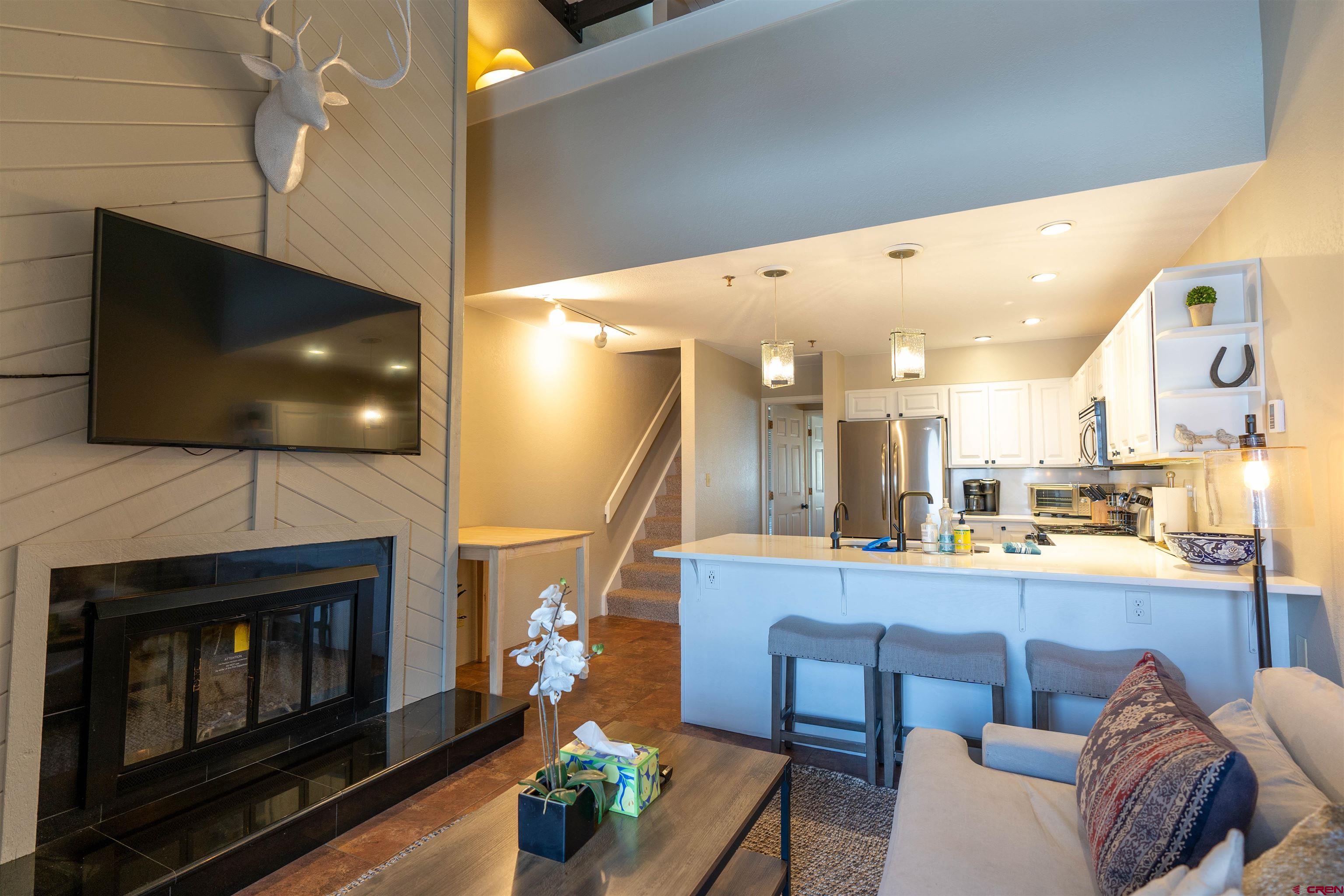 12 Snowmass Road, Unit 414 Crested Butte, CO 81225 - Photo 13 of 33 a living room with furniture and a flat screen tv