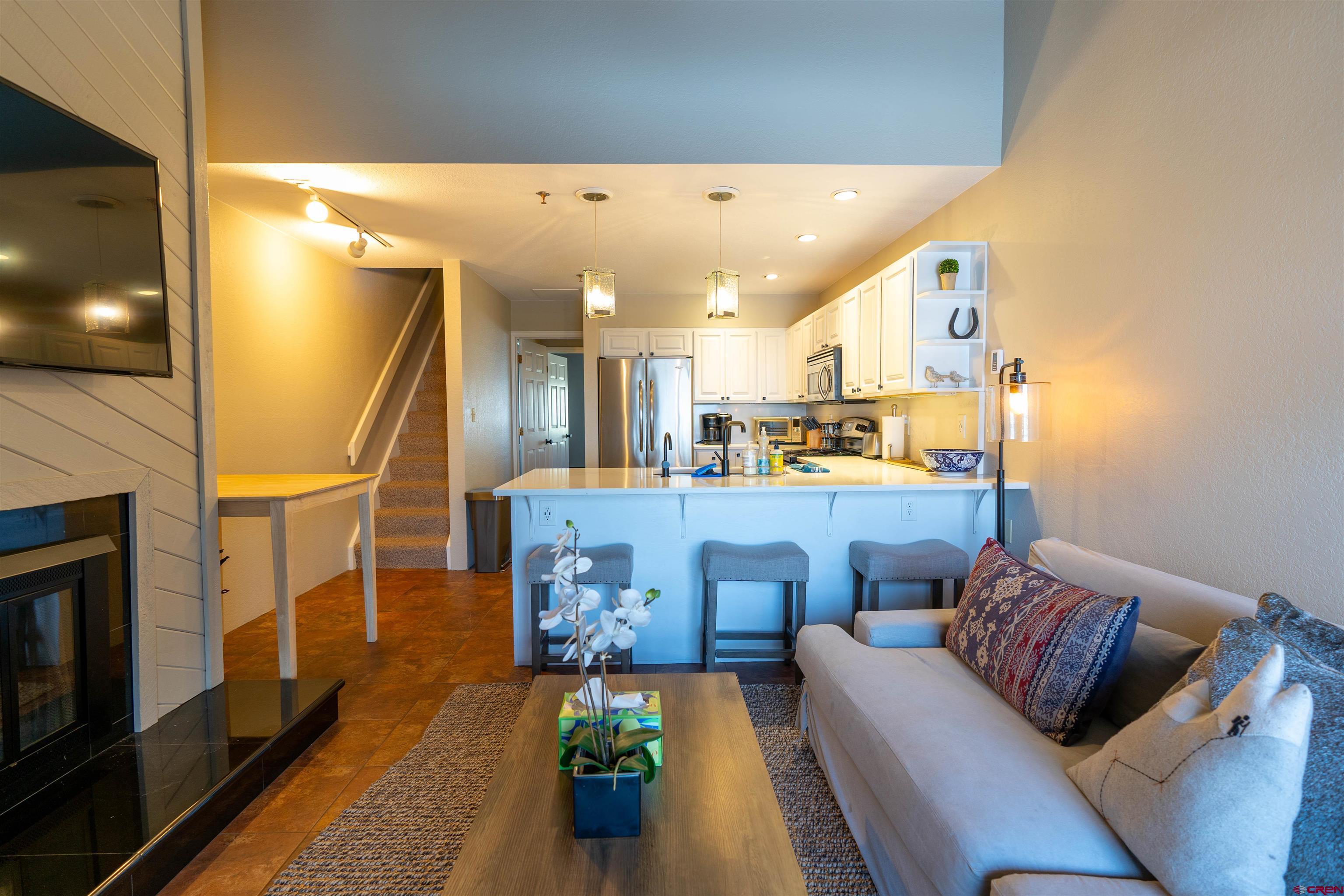12 Snowmass Road, Unit 414 Crested Butte, CO 81225 - Photo 16 of 33 a living room with furniture and a fireplace