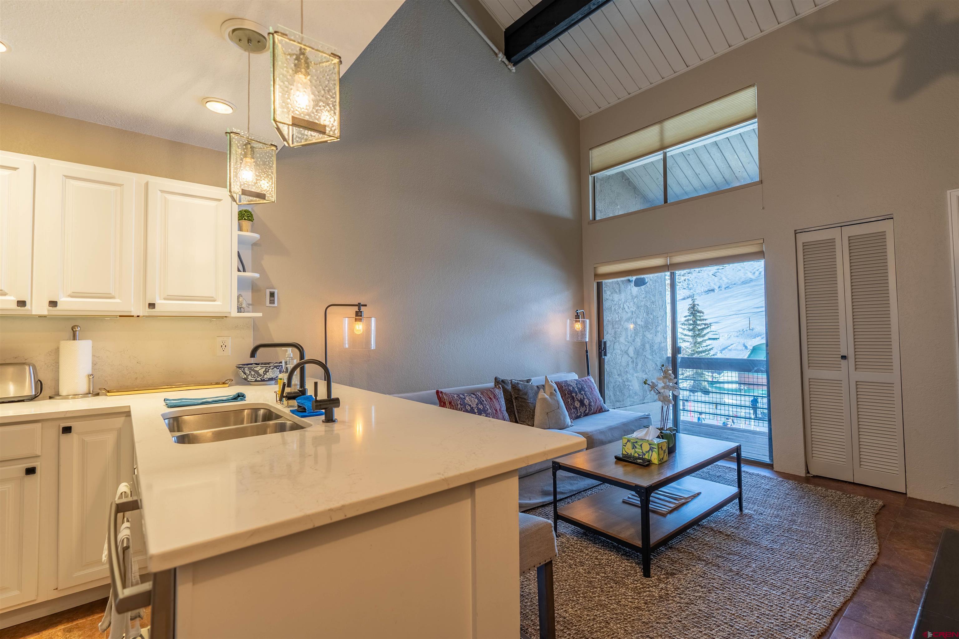 12 Snowmass Road, Unit 414 Crested Butte, CO 81225 - Photo 20 of 33 a kitchen with a sink cabinets and wooden floor