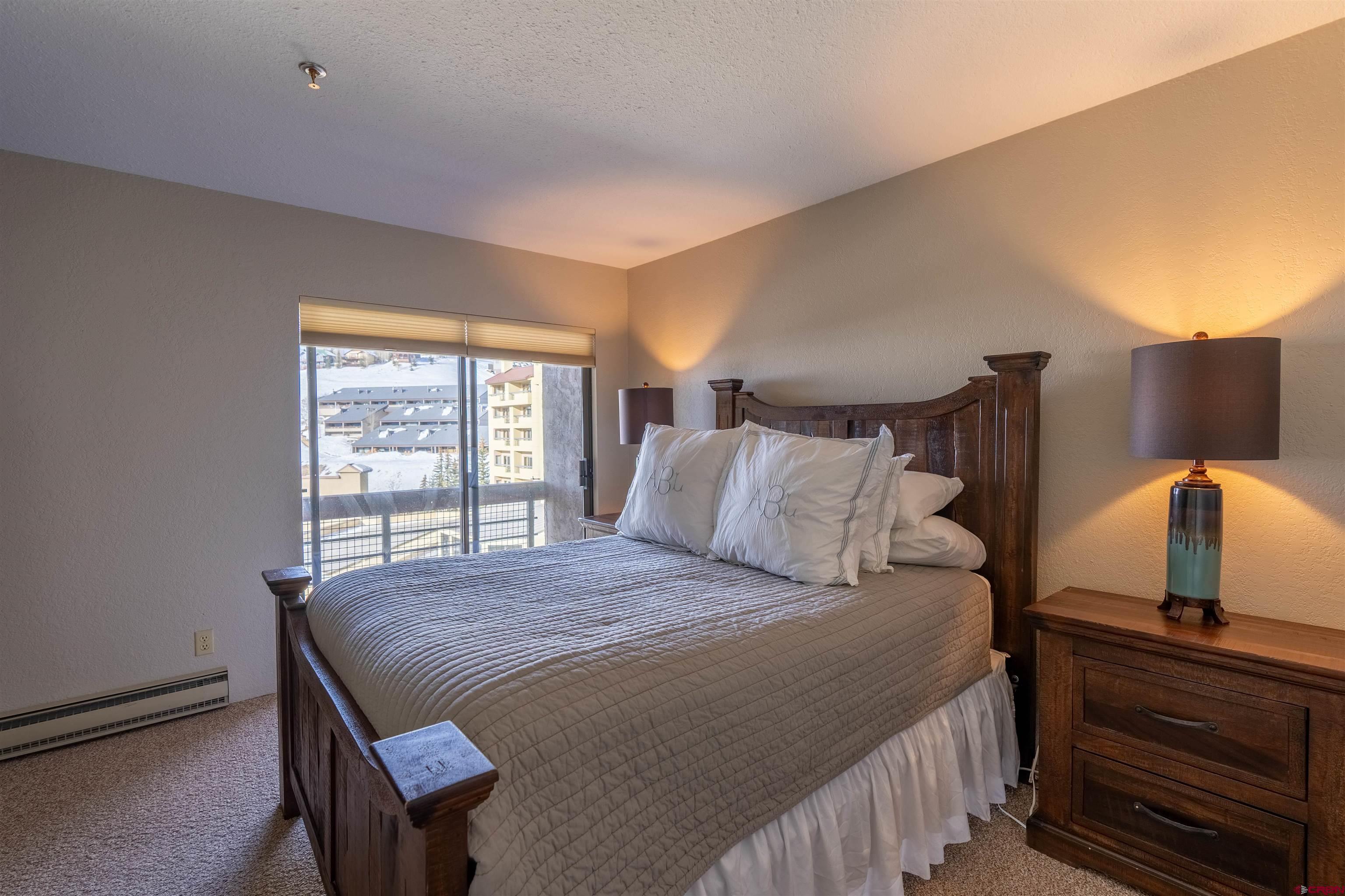12 Snowmass Road, Unit 414 Crested Butte, CO 81225 - Photo 23 of 33 a bedroom with a bed and window