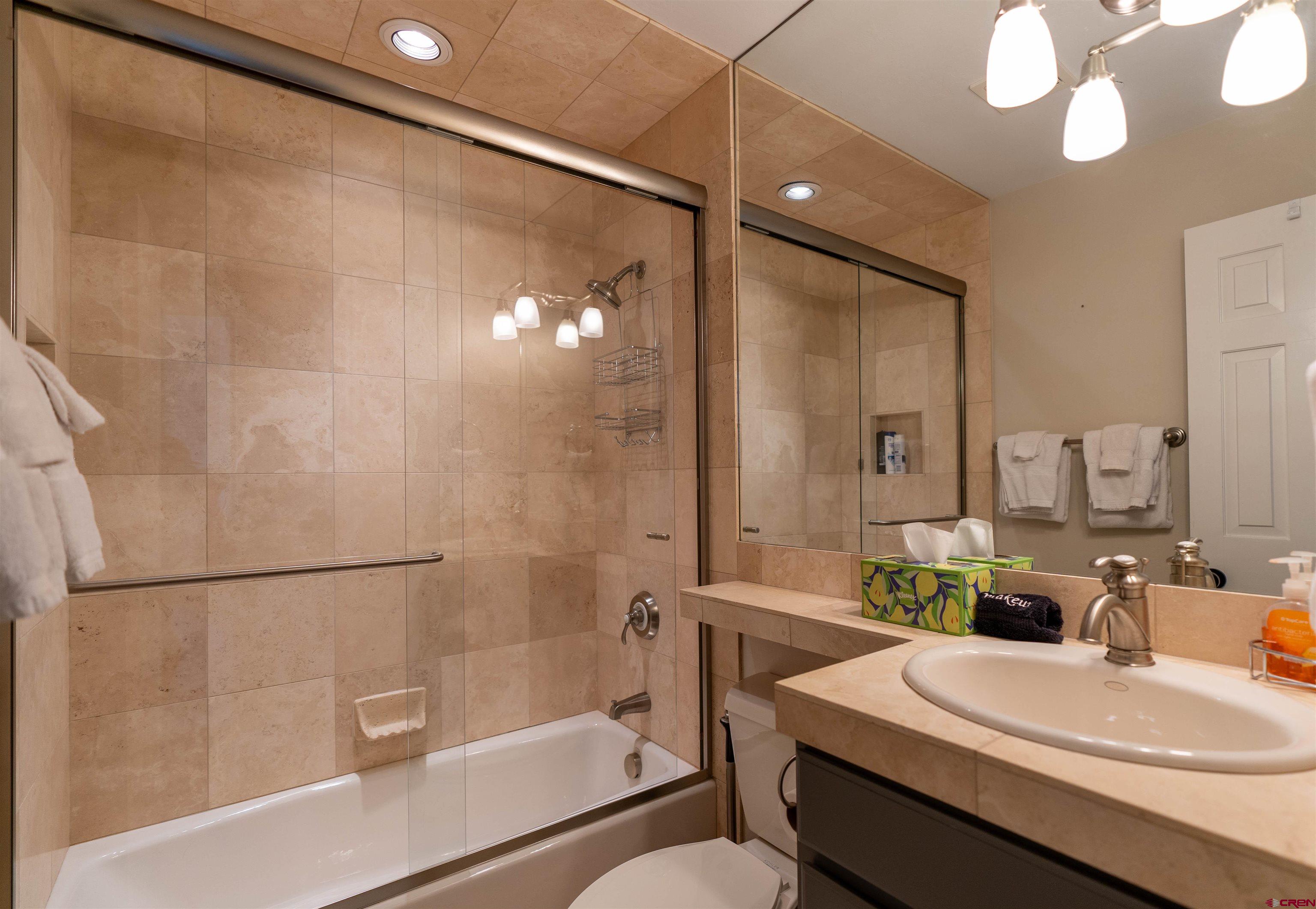 12 Snowmass Road, Unit 414 Crested Butte, CO 81225 - Photo 25 of 33 a bathroom with a sink a toilet and shower