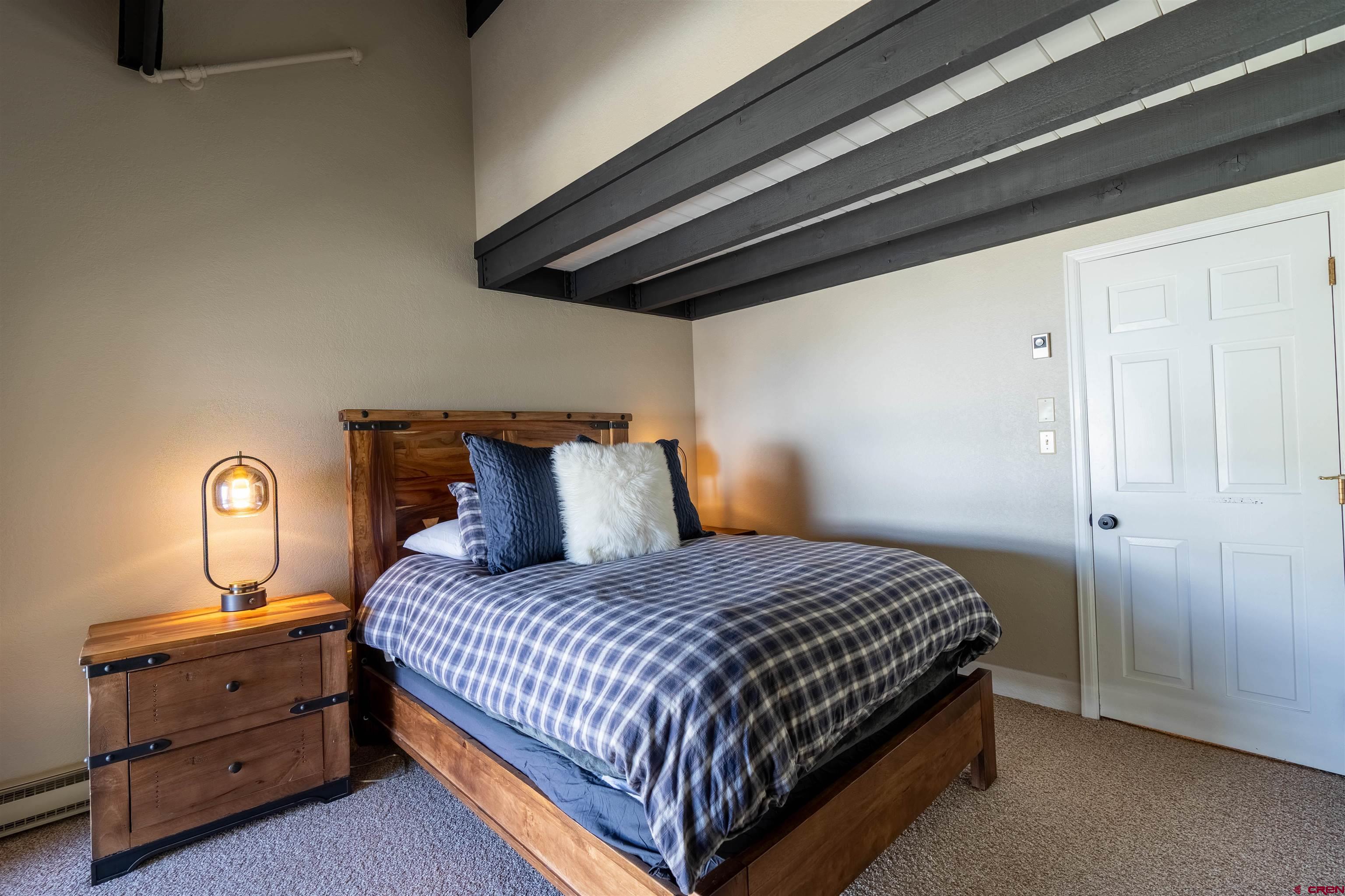 12 Snowmass Road, Unit 414 Crested Butte, CO 81225 - Photo 27 of 33 a bedroom with a bed and cabinet