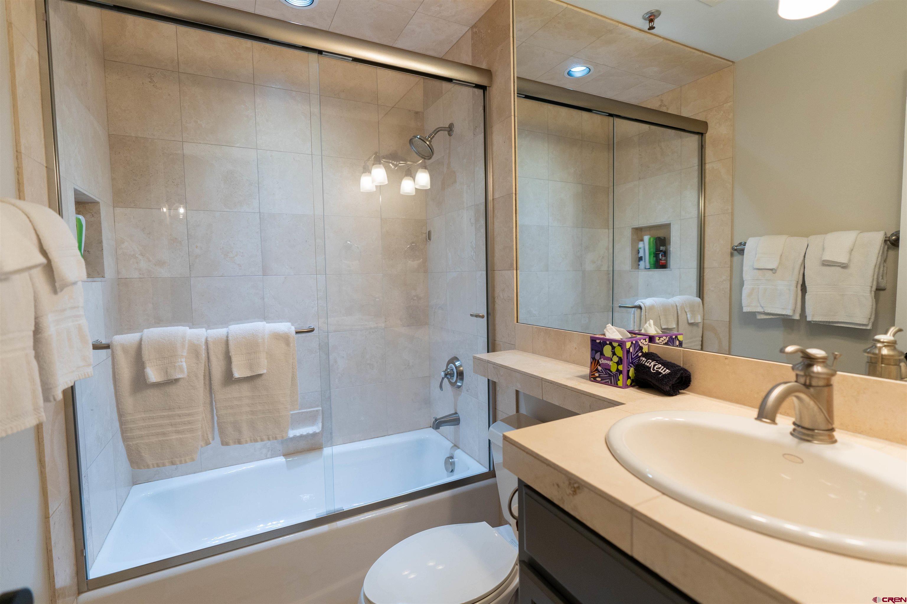 12 Snowmass Road, Unit 414 Crested Butte, CO 81225 - Photo 29 of 33 a bathroom with a sink toilet and shower