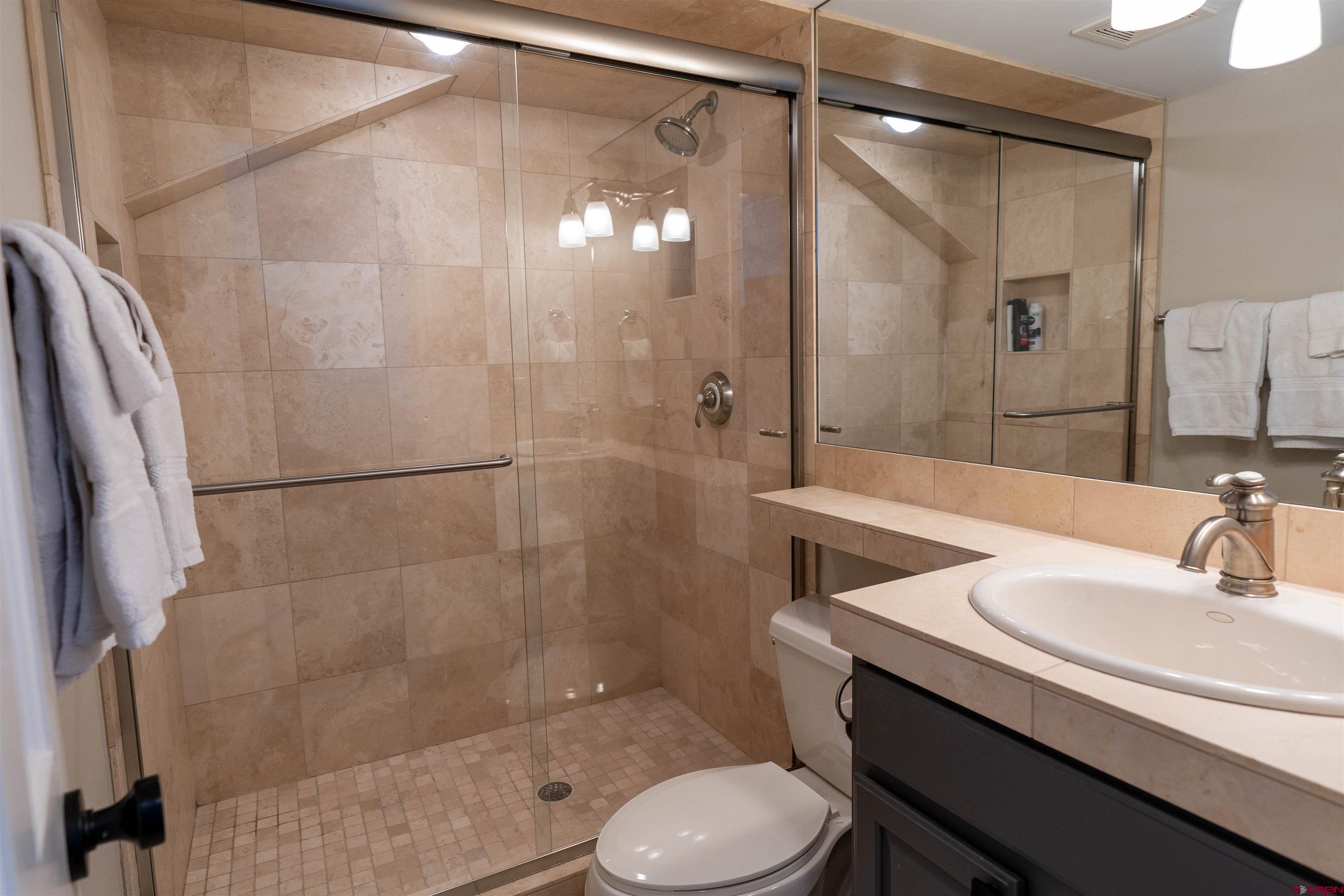 12 Snowmass Road, Unit 414 Crested Butte, CO 81225 - Photo 32 of 33 a bathroom with a sink toilet and shower