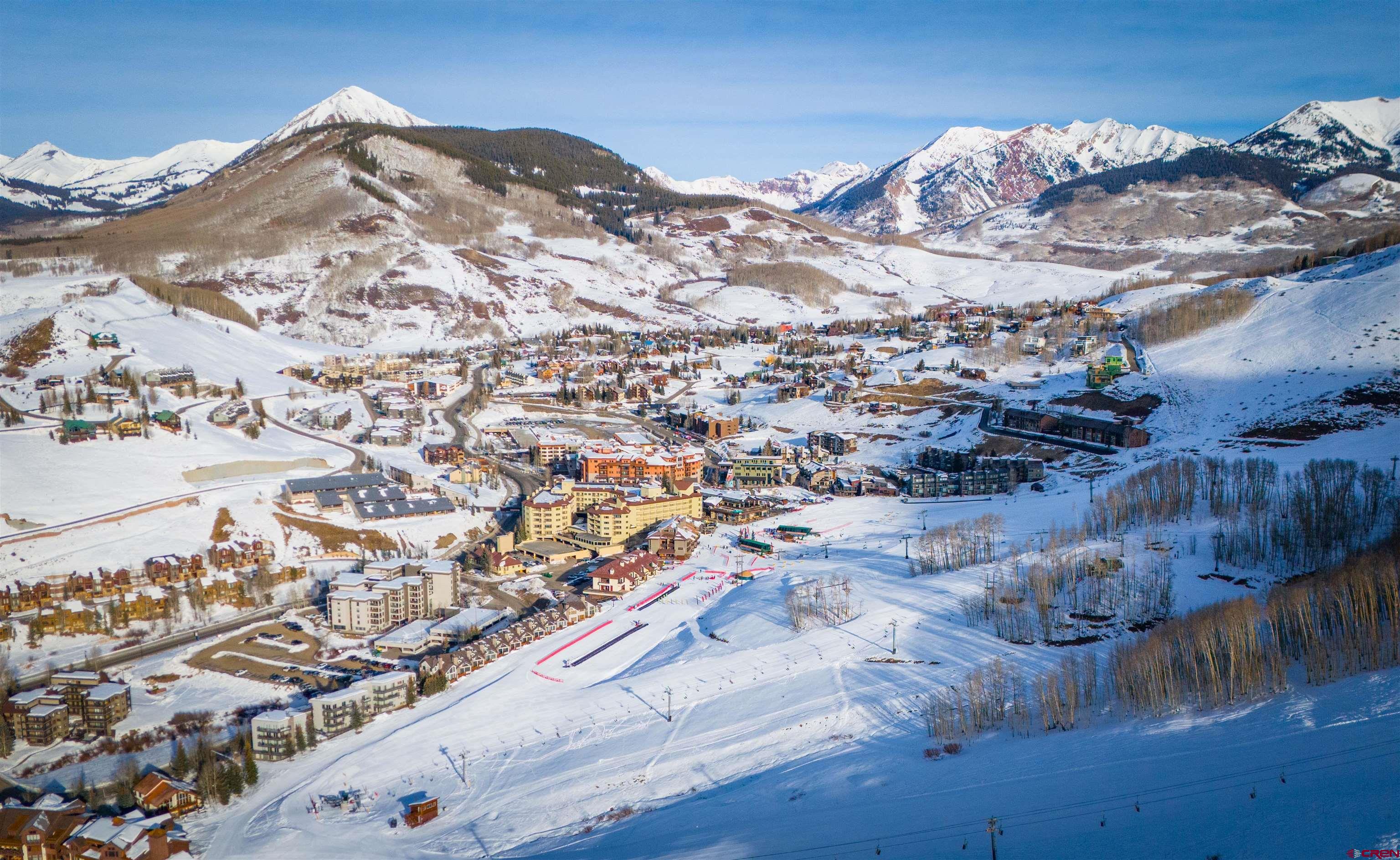 12 Snowmass Road, Unit 414 Crested Butte, CO 81225 - Photo 8 of 33 a view of a large building with mountains in the background