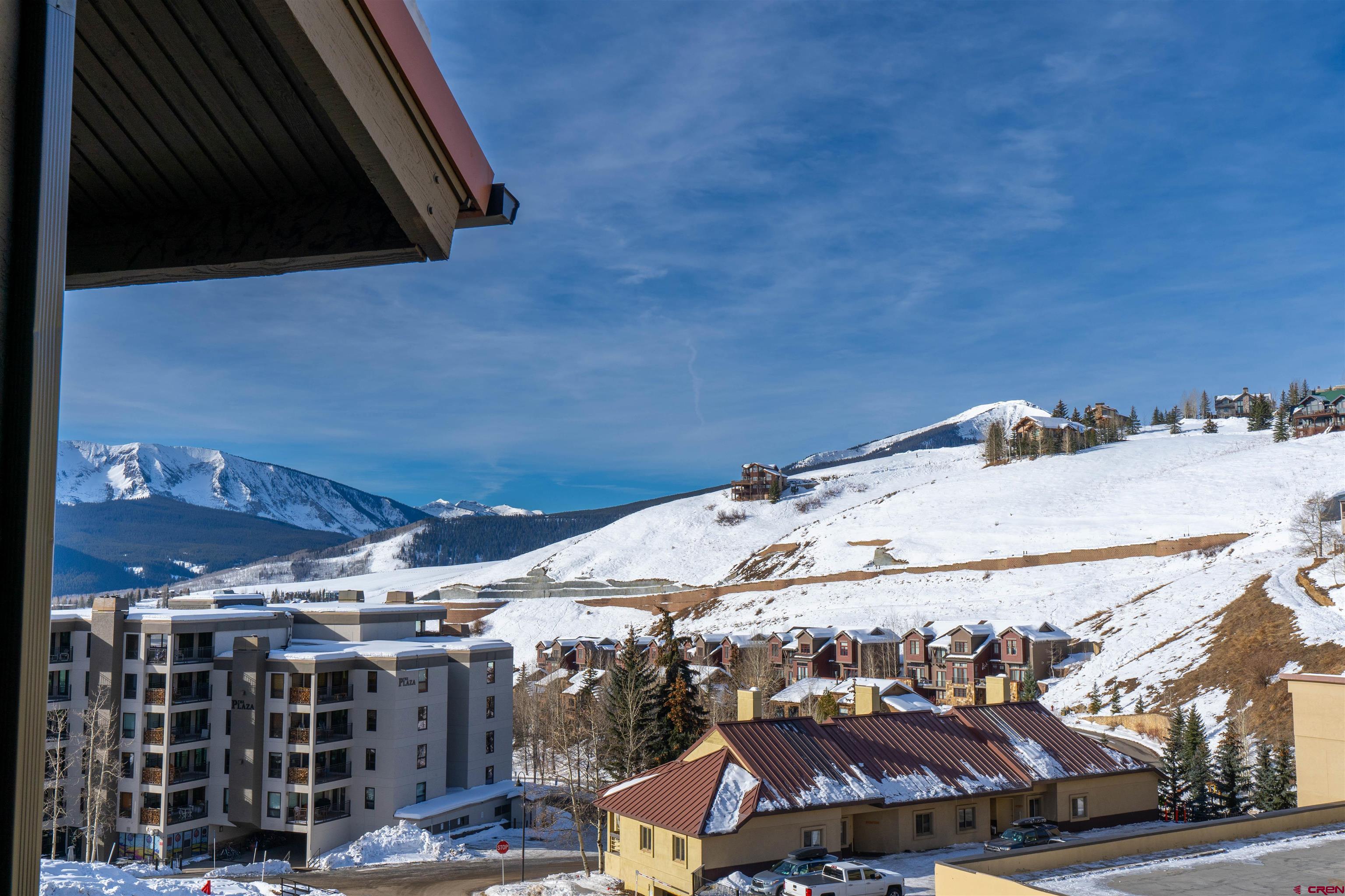 12 Snowmass Road, Unit 414 Crested Butte, CO 81225 - Photo 10 of 33 a view of a patio with table and chairs under an umbrella