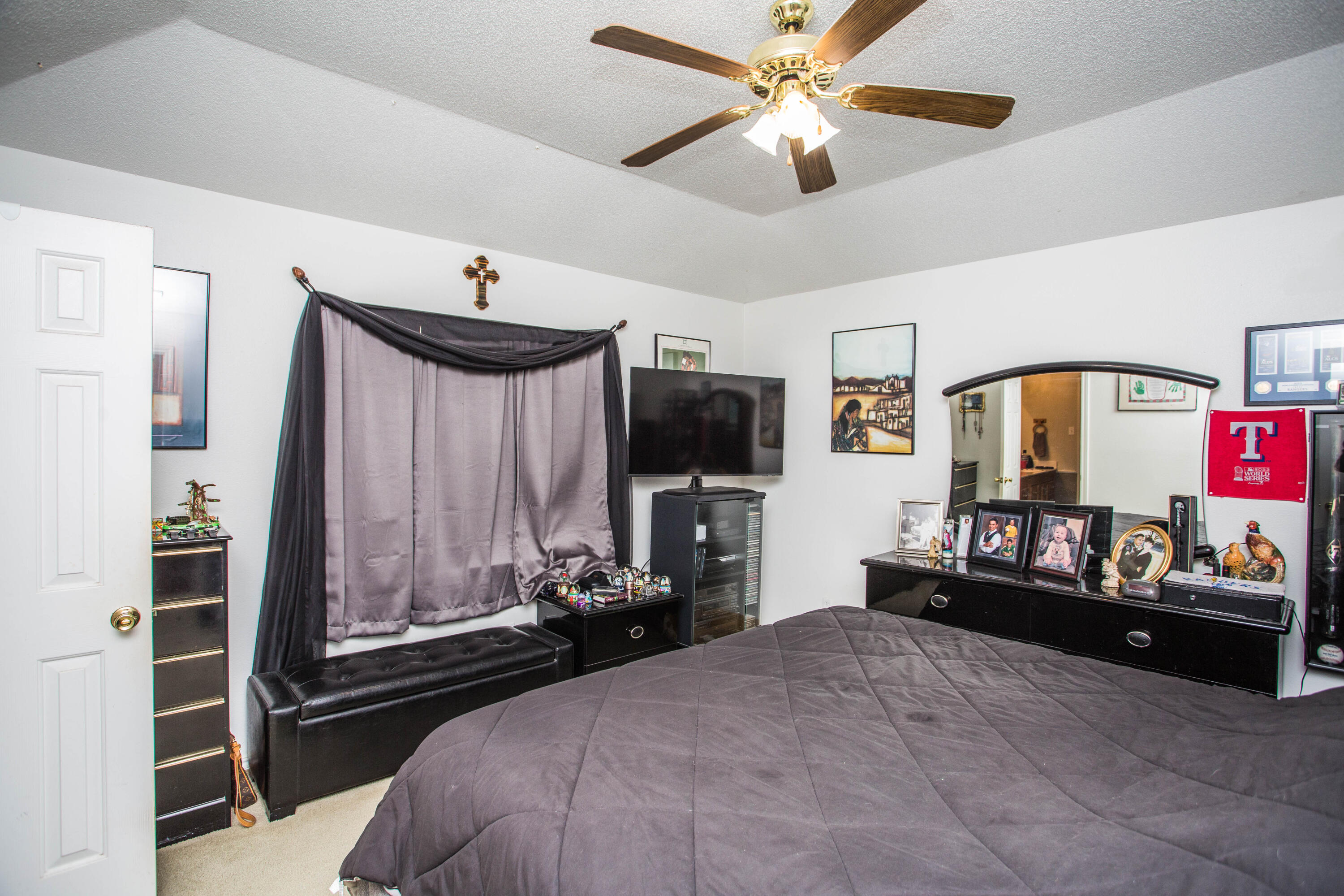 906 Xavier Street, Unit 1 Lubbock, TX 79403 - Photo 11 of 46 a bedroom with a bed and a chandelier