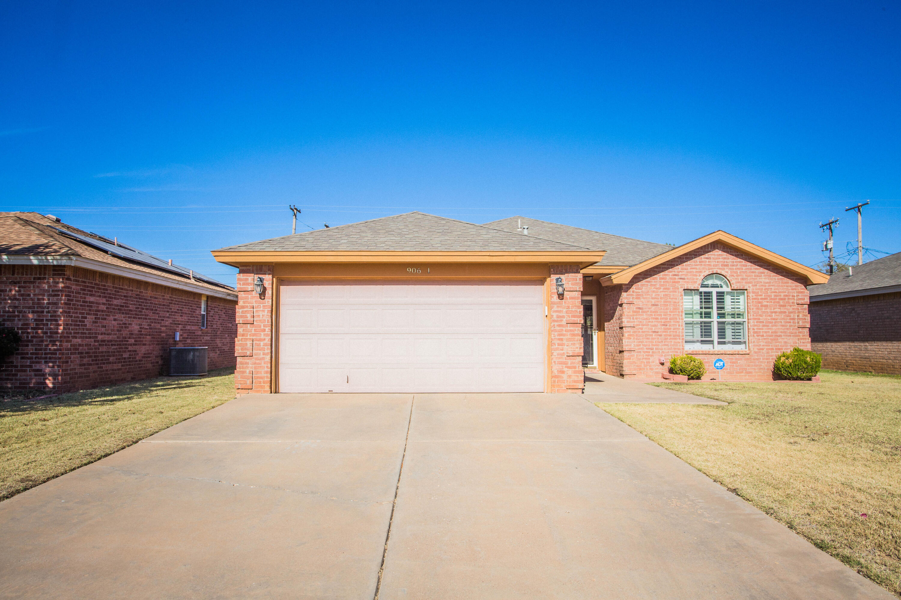 906 Xavier Street, Unit 1 Lubbock, TX 79403 - Photo 13 of 46 a view of a house with a yard and garage