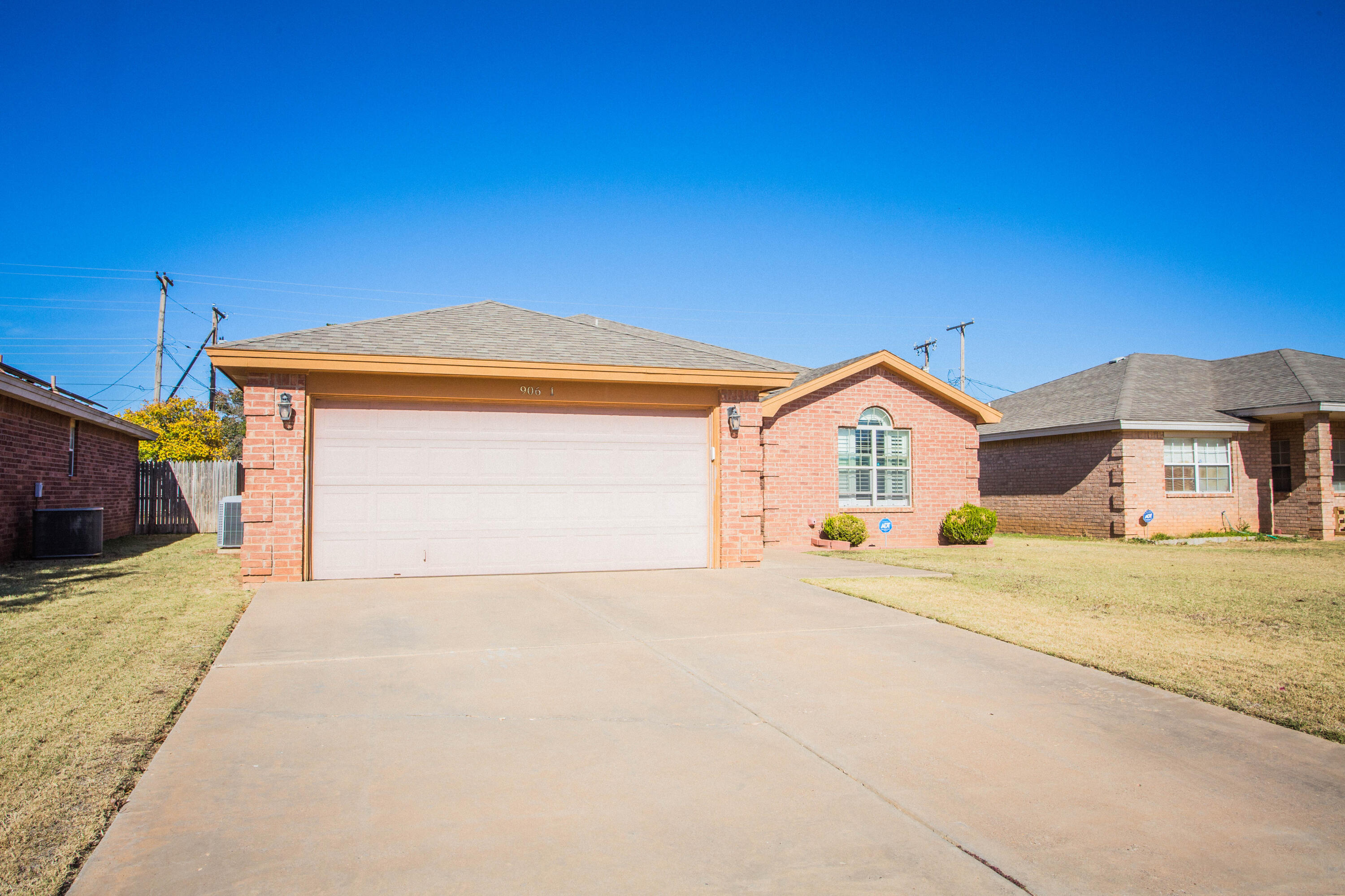 906 Xavier Street, Unit 1 Lubbock, TX 79403 - Photo 14 of 46 a front view of a house with a yard and garage