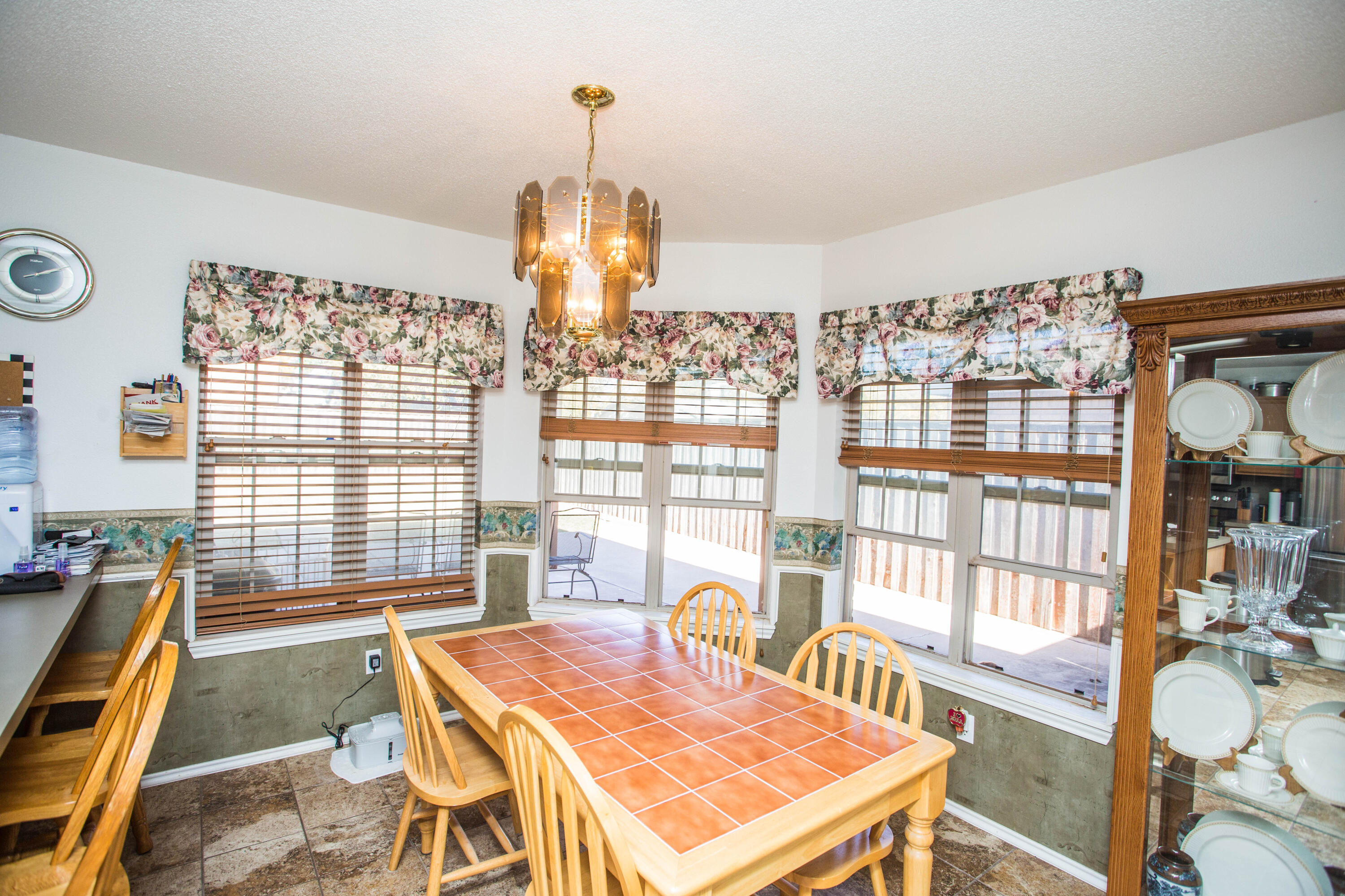906 Xavier Street, Unit 1 Lubbock, TX 79403 - Photo 28 of 46 a view of a dining room with furniture a chandelier and wooden floor