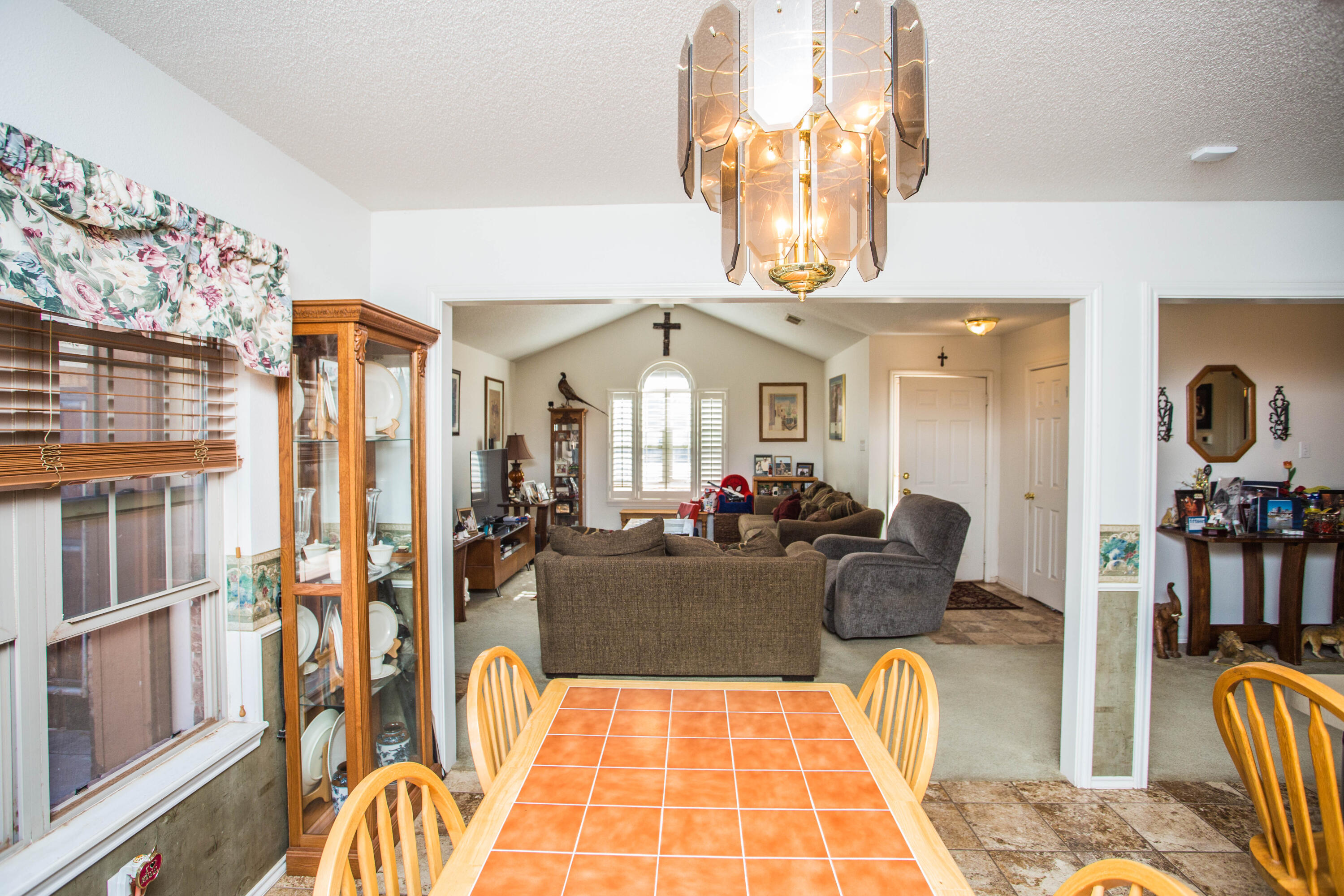 906 Xavier Street, Unit 1 Lubbock, TX 79403 - Photo 29 of 46 a living room with furniture a chandelier and flat screen tv