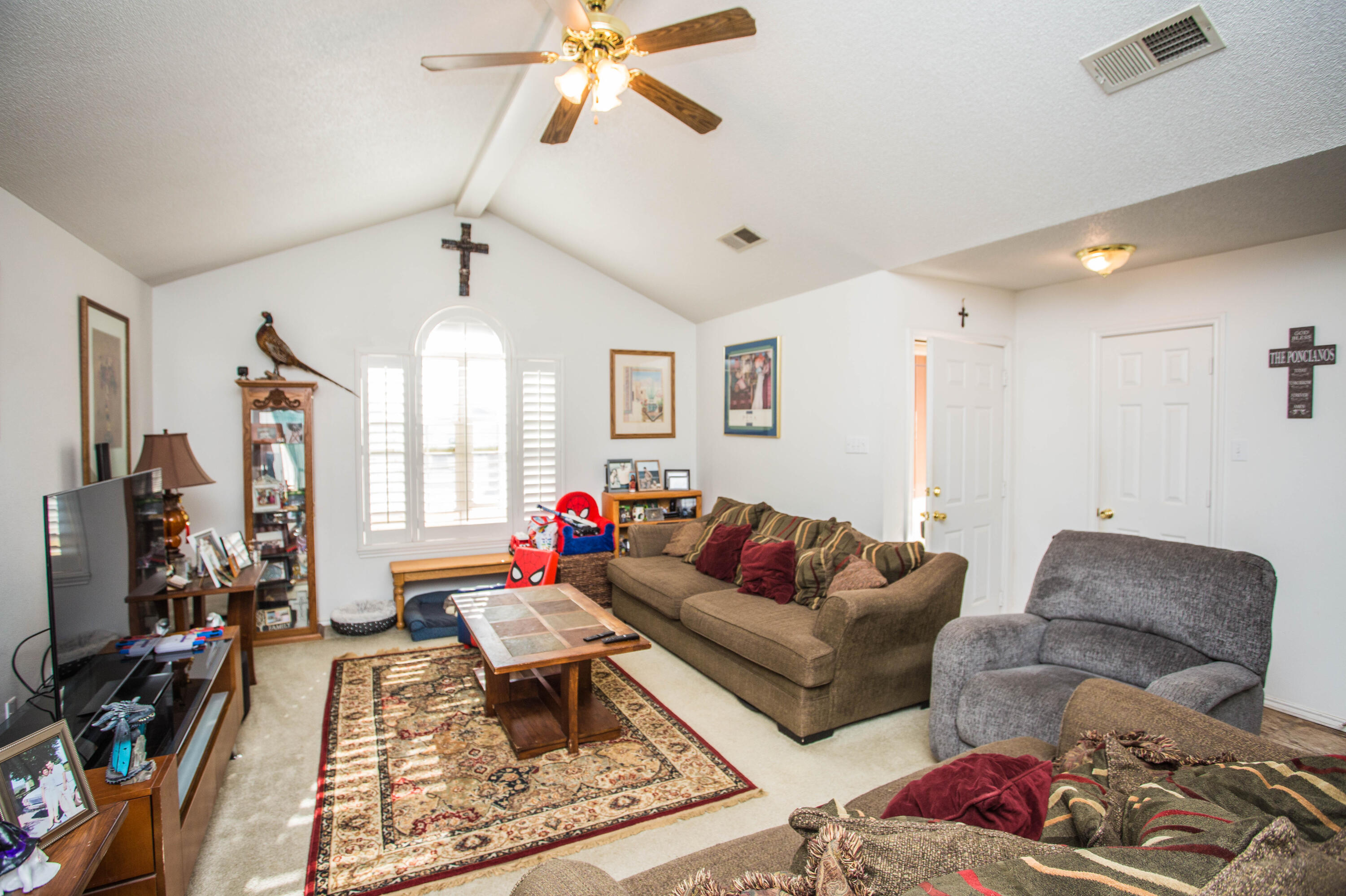 906 Xavier Street, Unit 1 Lubbock, TX 79403 - Photo 32 of 46 a living room with furniture a flat screen tv and a window