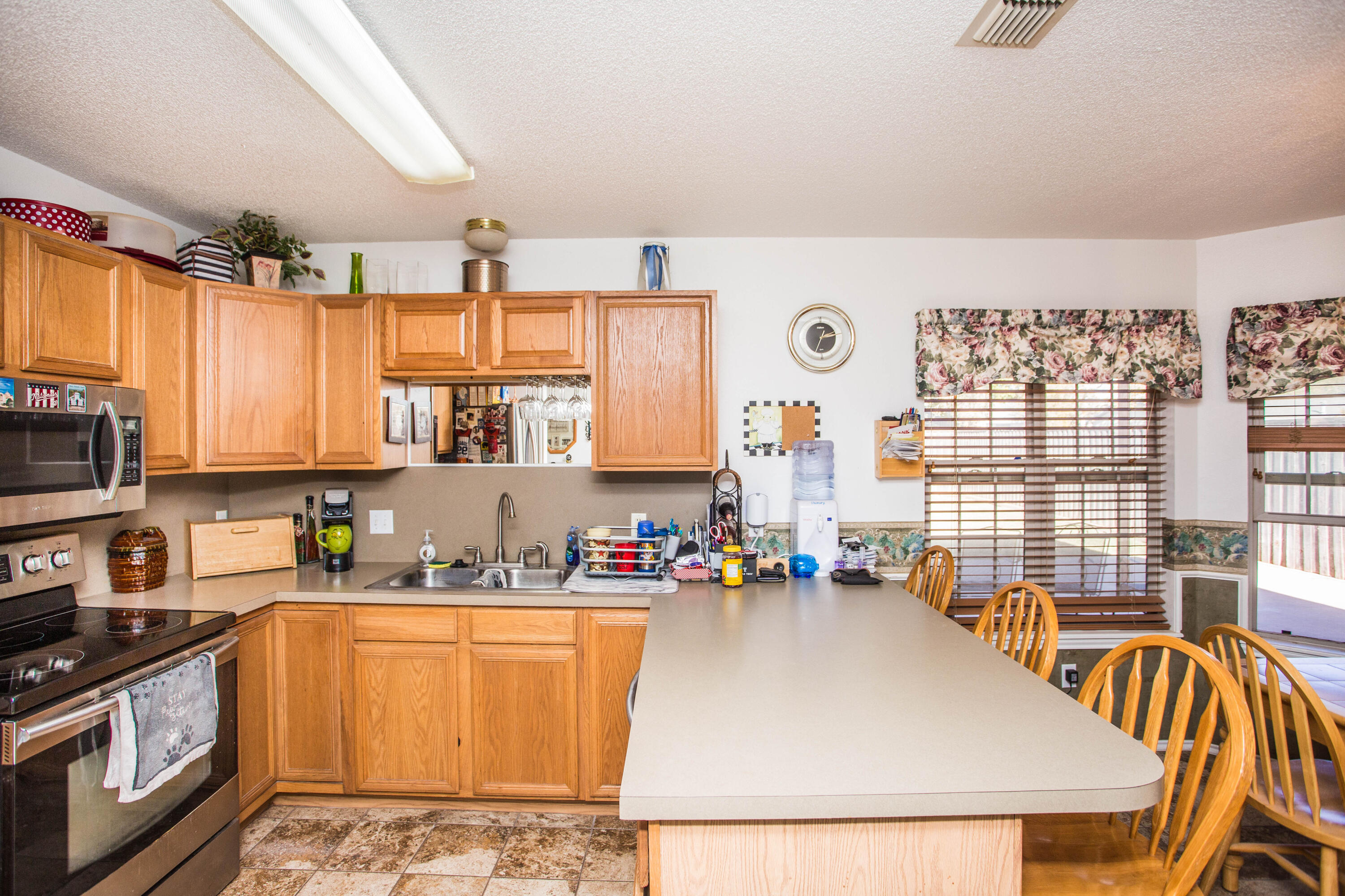 906 Xavier Street, Unit 1 Lubbock, TX 79403 - Photo 35 of 46 a kitchen with stainless steel appliances a stove a sink a microwave and a refrigerator