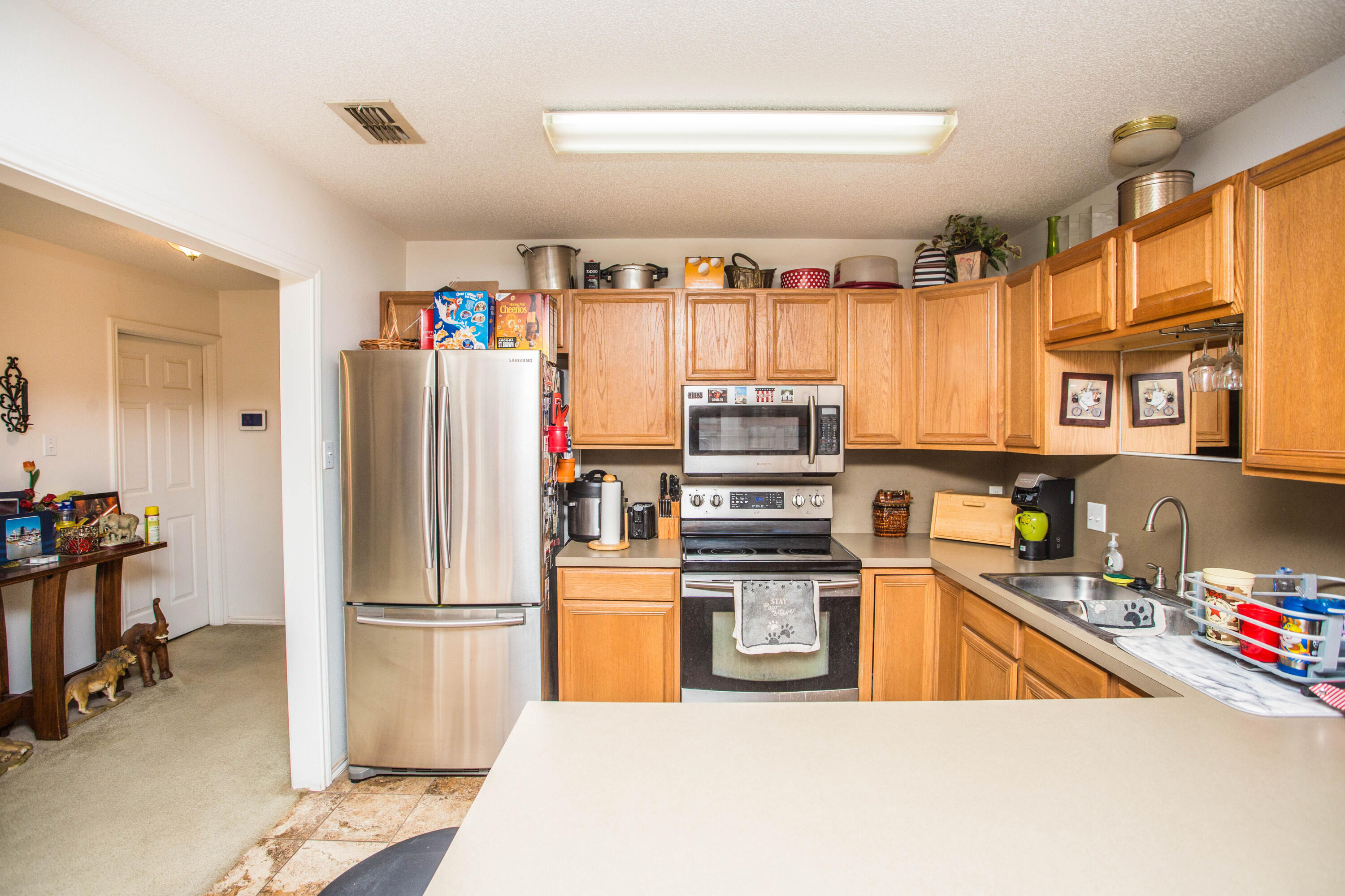 906 Xavier Street, Unit 1 Lubbock, TX 79403 - Photo 38 of 46 a kitchen with stainless steel appliances a refrigerator and a sink