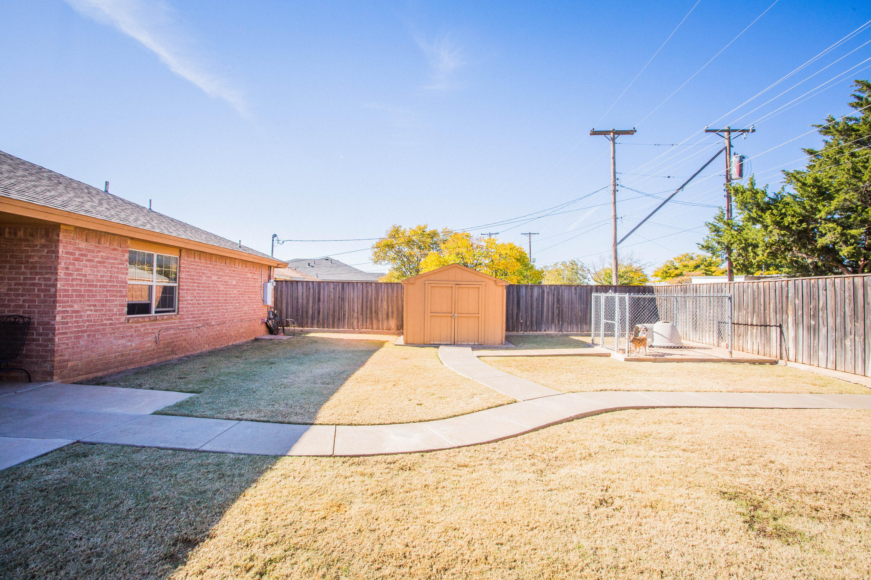 906 Xavier Street, Unit 1 Lubbock, TX 79403 - Photo 39 of 46 a white house with a yard and fence