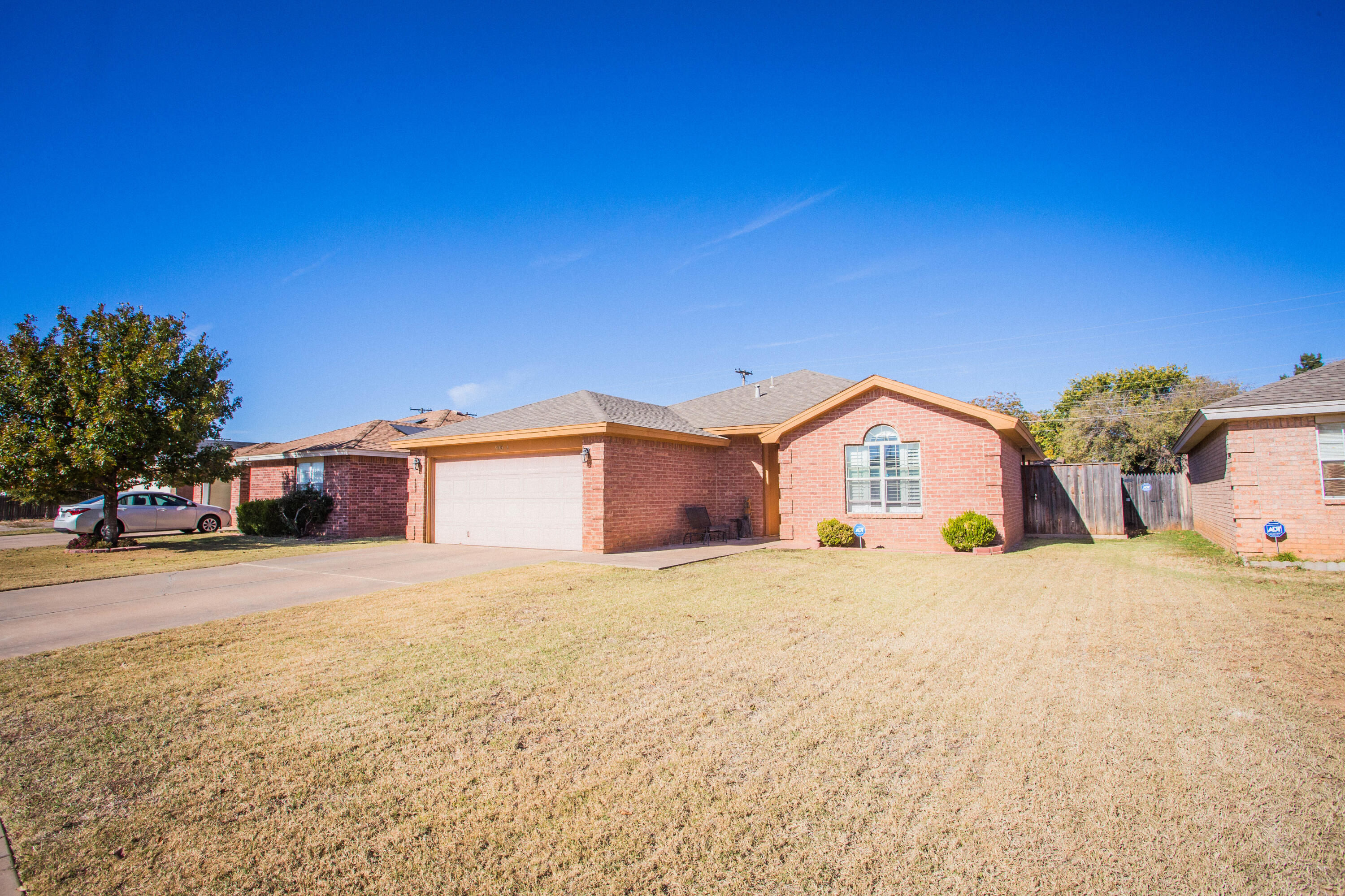 906 Xavier Street, Unit 1 Lubbock, TX 79403 - Photo 45 of 46 a large house with a big yard and large trees