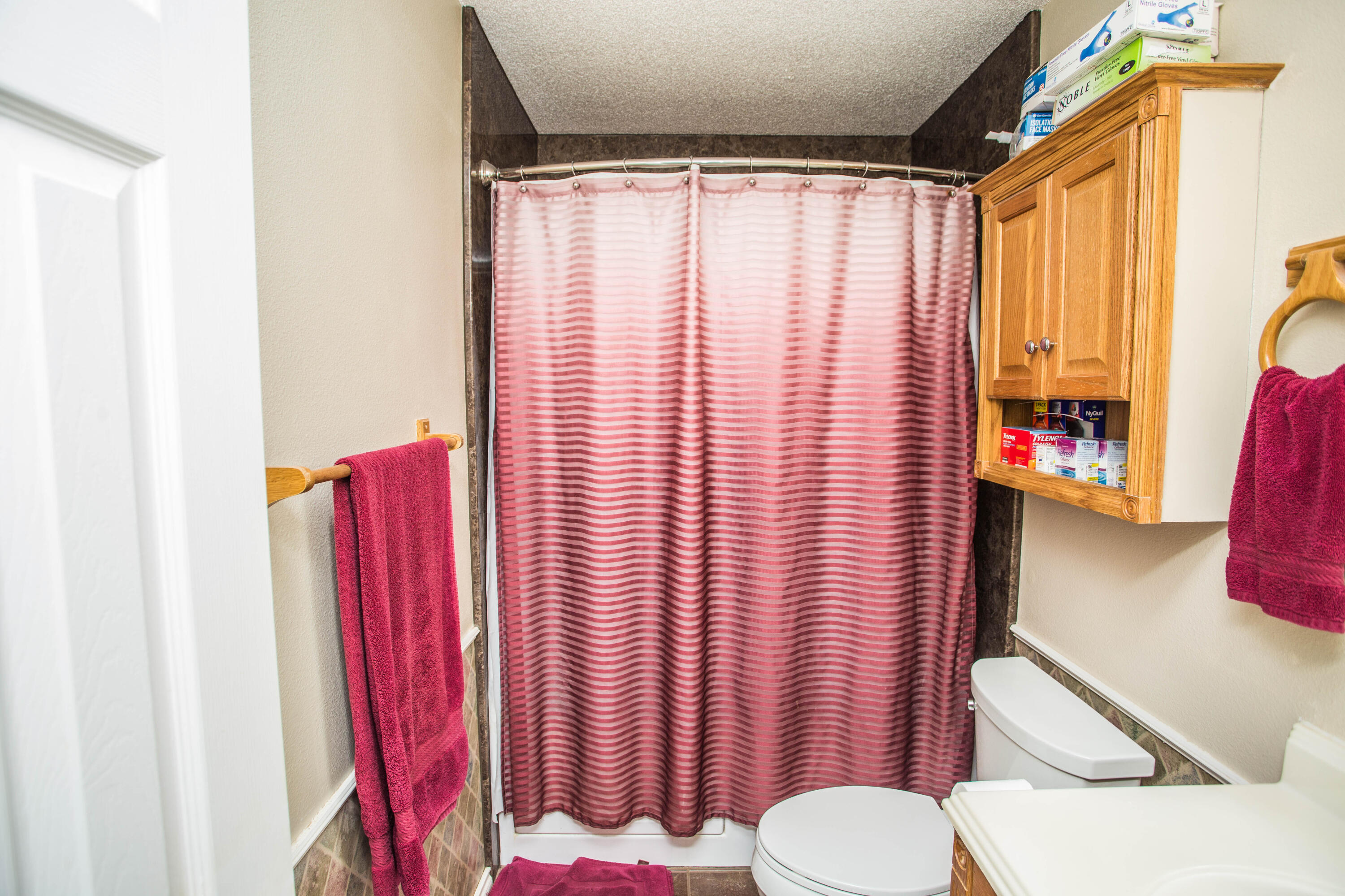 906 Xavier Street, Unit 1 Lubbock, TX 79403 - Photo 7 of 46 a bathroom with a shower curtain and a sink