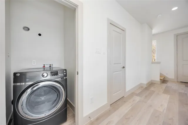 a view of a hallway with washer and dryer