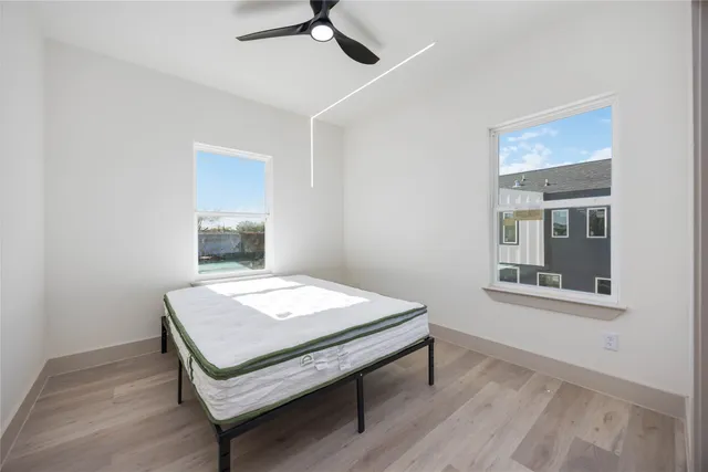 a room with a table chairs and wooden floor