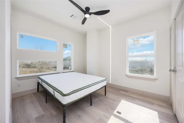 a living room with a bed and a window