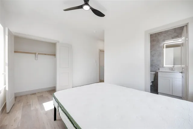 a bedroom with a bed and cabinets