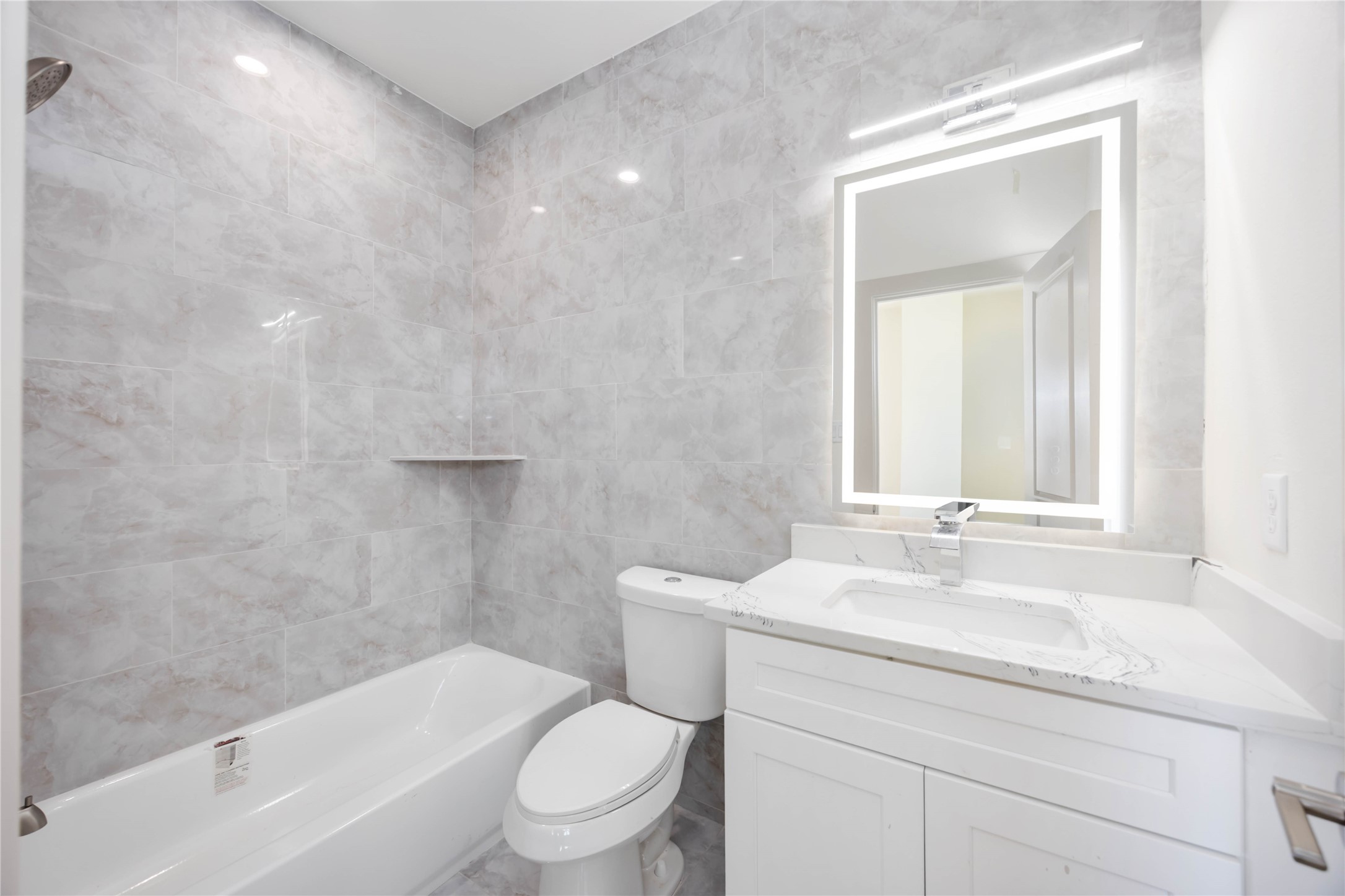 3206 Retta Street Houston, TX 77026 - Photo 17 of 19 a bathroom with a granite countertop toilet a sink and a bathtub