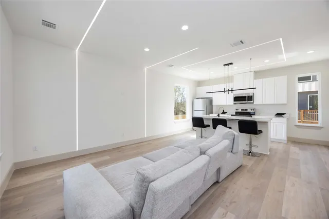 a living room with furniture and kitchen view