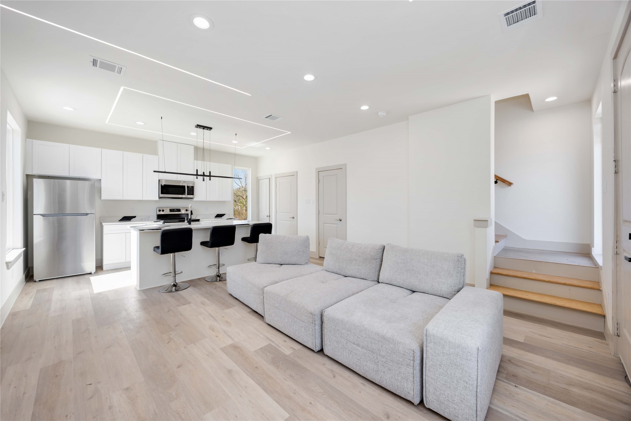 3206 Retta Street Houston, TX 77026 - Photo 6 of 19 a living room kitchen with stainless steel appliances kitchen island granite countertop a refrigerator and a stove top oven