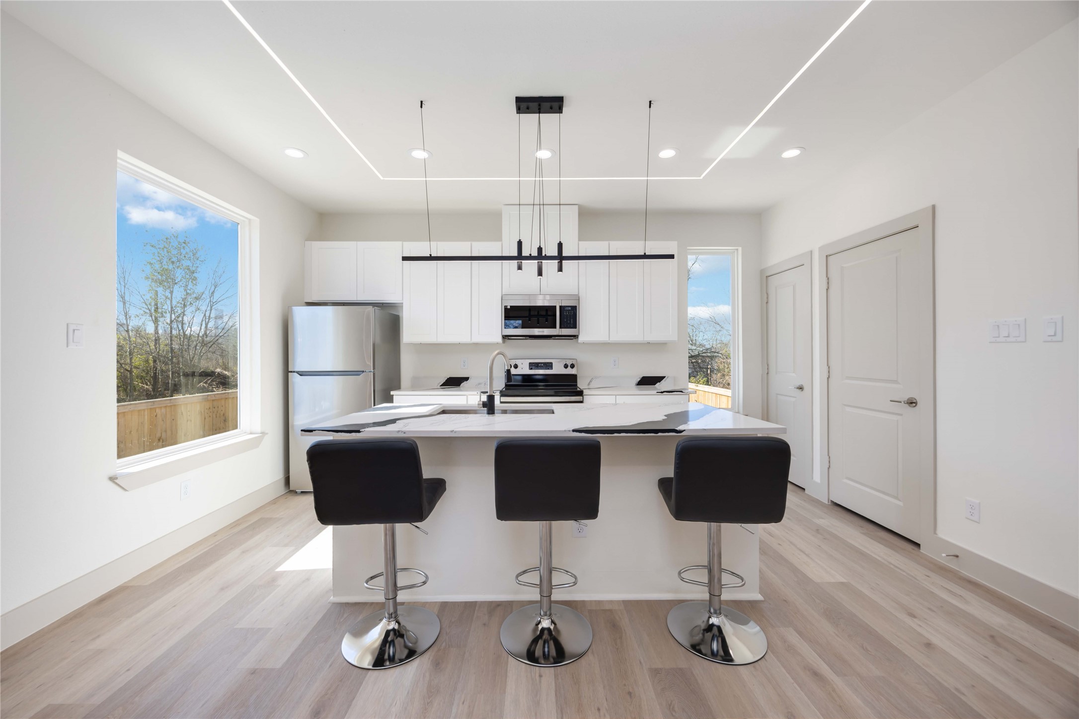 3206 Retta Street Houston, TX 77026 - Photo 9 of 19 a view of kitchen with microwave stove refrigerator dining table and chairs