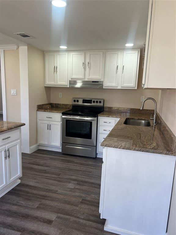 228 Bodcau Station Road Haughton, LA 71037 - Photo 4 of 16 a kitchen with granite countertop wooden cabinets and a stove