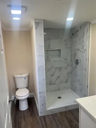 a bathroom with a toilet and a shower