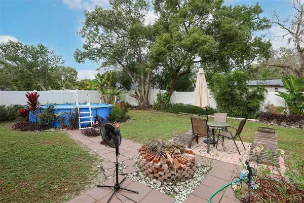 a view of a house with backyard sitting area and garden