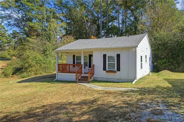 a view of a house with backyard porch and sitting area
