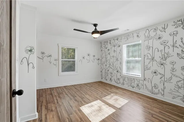 wooden floor in an empty room with a window