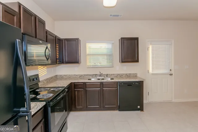 a kitchen that has a sink and a stove