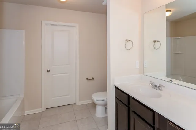 a bathroom with a sink a toilet a shower and a mirror