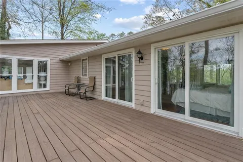 a living room with a floor to ceiling window and wooden floor