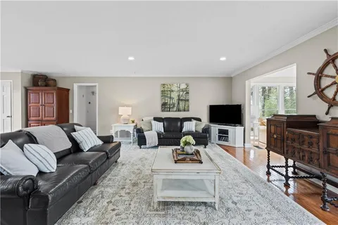 a kitchen with stainless steel appliances granite countertop a stove and a wooden floors