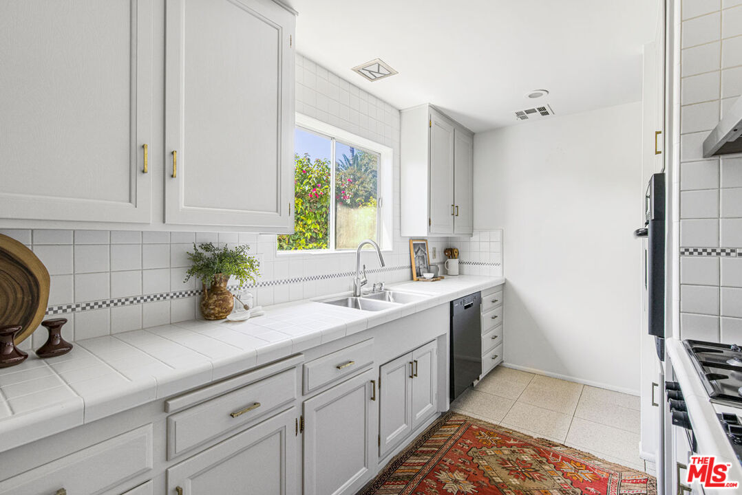 2015 Panamint Drive Los Angeles, CA 90065 - Photo 11 of 29 a kitchen with a sink stove and cabinets