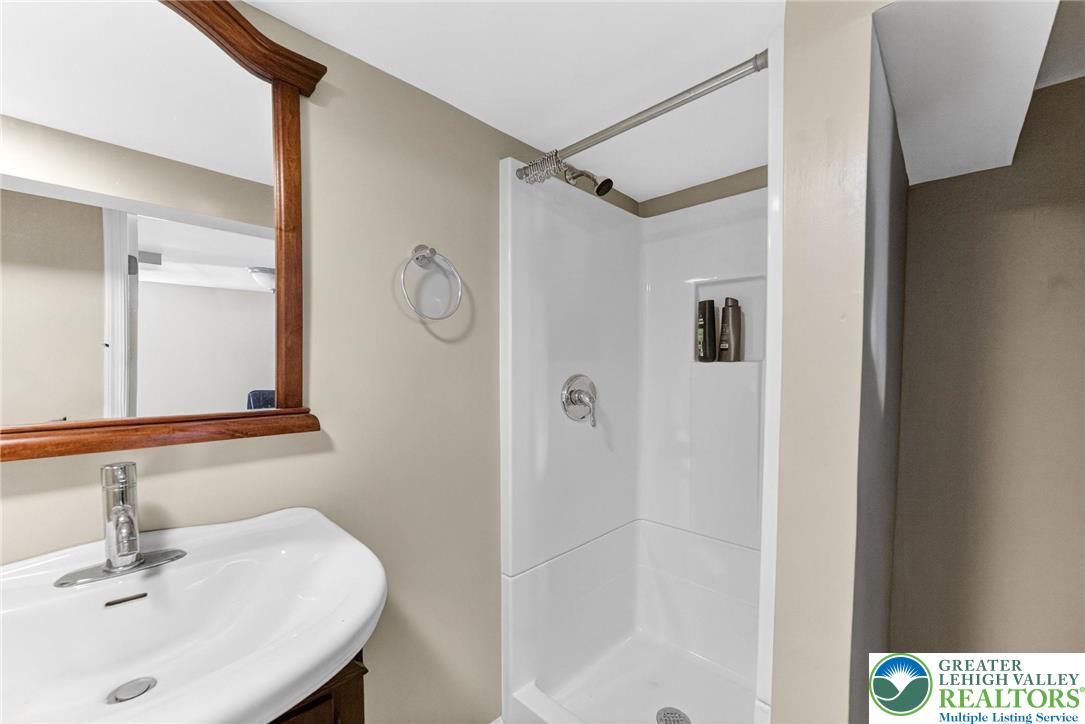 5370 Hanoverville Road Bethlehem, PA 18017 - Photo 20 of 24 a bathroom with a shower sink and mirror