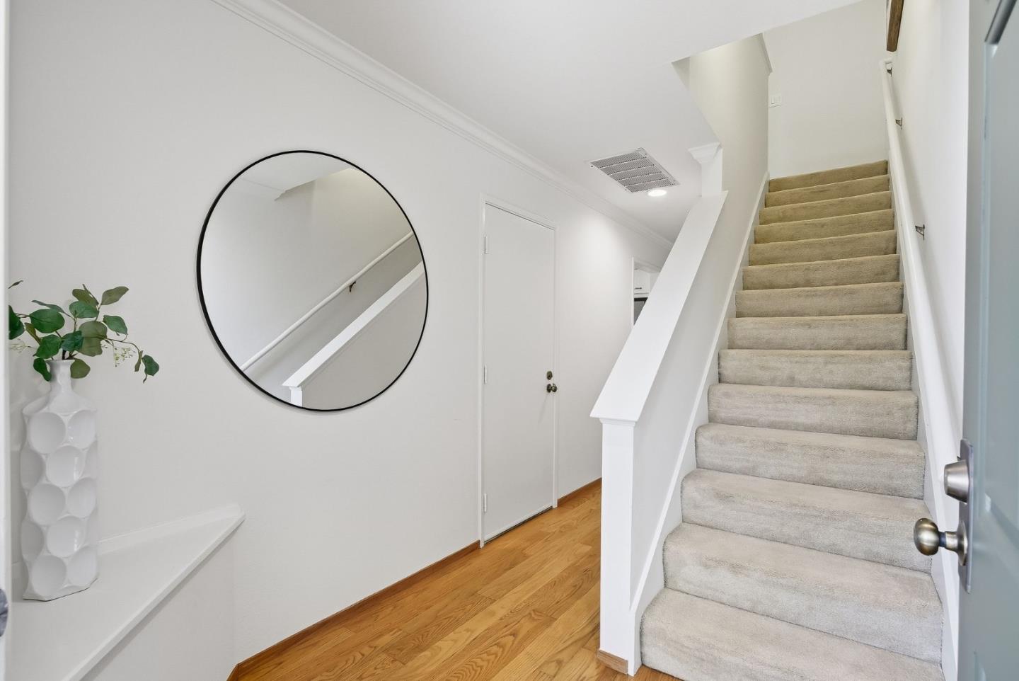 181 Ada Avenue, Unit 29 Mountain View, CA 94043 - Photo 11 of 30 a view of staircase with white walls and a wooden floor