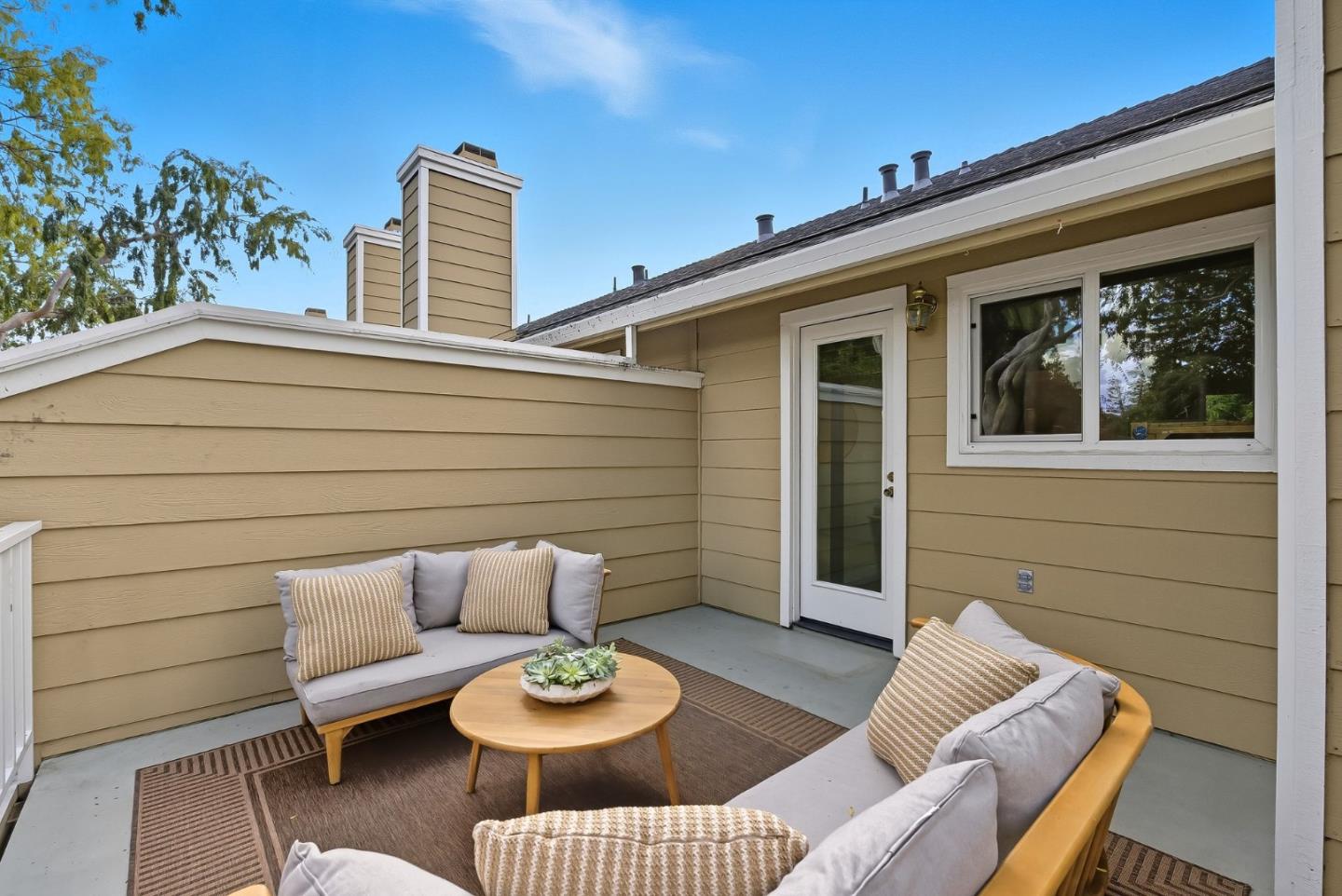 181 Ada Avenue, Unit 29 Mountain View, CA 94043 - Photo 18 of 30 a view of a patio with couches table and chairs and potted plants