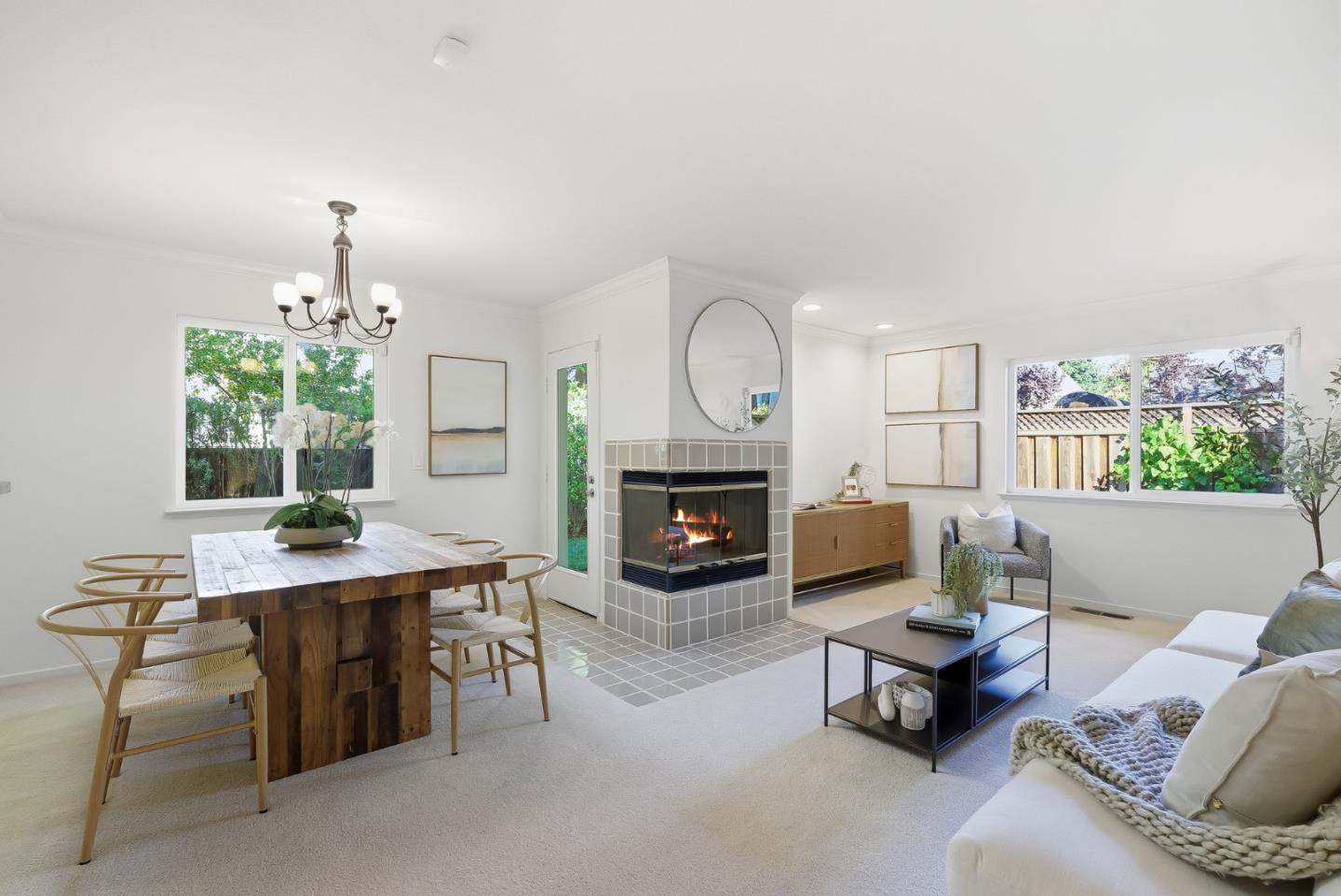 181 Ada Avenue, Unit 29 Mountain View, CA 94043 - Photo 5 of 30 a living room with furniture a fireplace and a chandelier